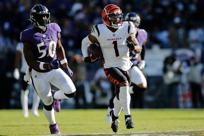 Cincinnati Bengals wide receiver Ja'Marr Chase (1) breaks tackles as he takes a reception 82 yards for a touchdown in the third quarter of the NFL Week 7 game between the Baltimore Ravens and the Cincinnati Bengals at M&T Bank Stadium in Baltimore on Sunday, Oct. 24, 2021. The Bengals moved into the top of the AFC North with a 41-17 win over the Ravens. 