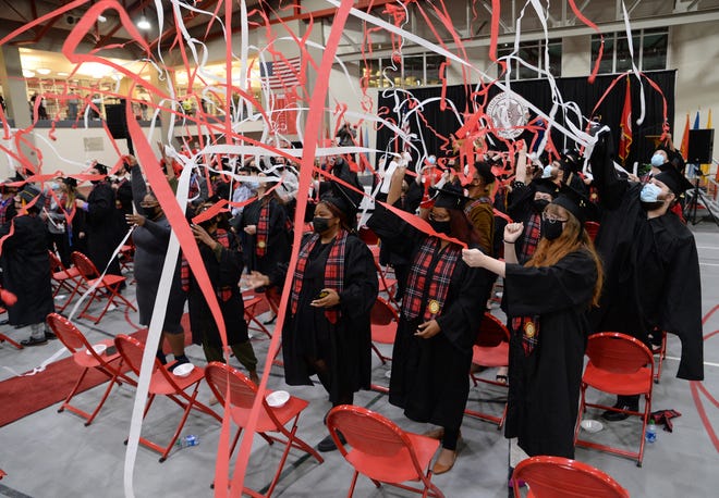 Members of the Monmouth College Class of 2020 celebrate during their commencement ceremony, held Sunday morning in the Huff Athletic Center. A total of 59 members of the Class of 2020 participated in the ceremony, which was held during the college’s homecoming 2021 weekend.