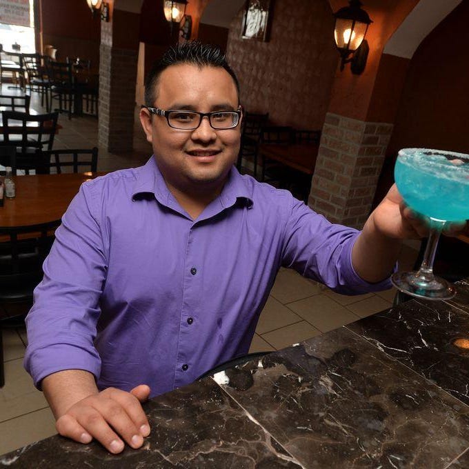 Mauricio Martinez of Blue Margaritas Mexican Bar and Grill displays one of the drinks the Peoria restaurant at 9010 North Allen Road in the Prairie Pointe Shopping Center is famous for.