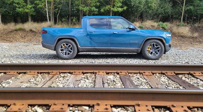 The 2022 Rivian R1T boasts standard clearance of 11.5 inches. Using air suspension it can squat to 8 inches for better highway dynamics (pictured) or jump to 14 inches for off-road duty.