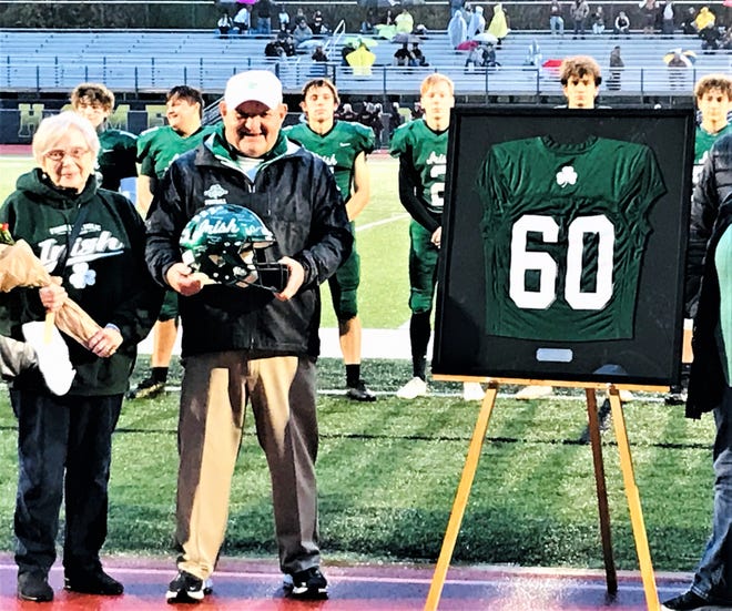 Fisher Catholic assistant coach John Young was honored before the Fisher Catholic-Berne Union football game. This season marked 60 years as a high school football coach for Young.