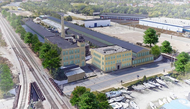 A plan to convert historic industrial buildings in Milwaukee's Harbor District into apartments is now adding a newly constructed building.