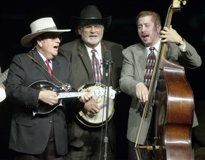 Bobby Osborne, left, plays the mandolin, Sonny Osborne, middle, plays the banjo and Daryl Mosley, on bass, sing "Kentucky," Thursday afternoon, April 11, 2002, during the International Bluegrass Music Museum's grand reopening at the RiverPark Center in Owensboro, Ky. (AP Photo/The Messenger-Inquirer, John Dunham)