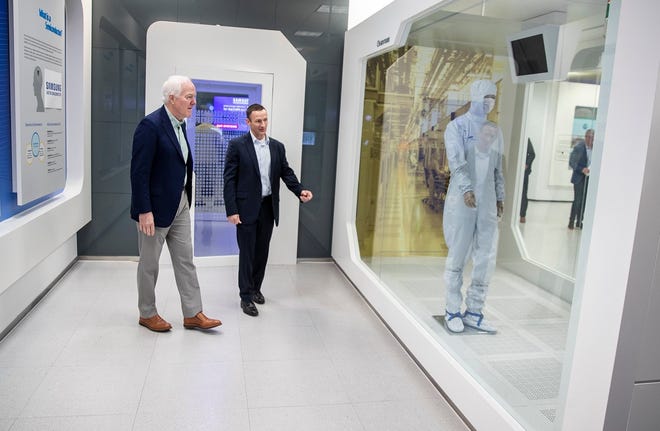 In this file photo, Sen. John Cornyn, R-Texas, takes a tour of Samsung's Austin facility with Jon Taylor, Samsung's vice president of fab engineering.  Samsung says it is considering Austin and Taylor as potential sites for a planned $17 billion chip-making facilty.