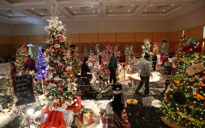 Visitors look at the decorated trees on display Nov. 29, 2019, during the Saint Vincent Festival of Trees at the Bayfront Convention Center. This year's event runs Nov. 26, 27 and 28.