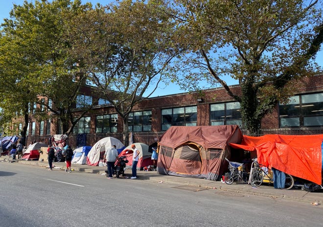Clusters of tents form makeshift living space along Southampton Street in the "Mass. and Cass" area on Sunday, Sept. 26, directly across from the Boston Fire Department administrative headquarters.