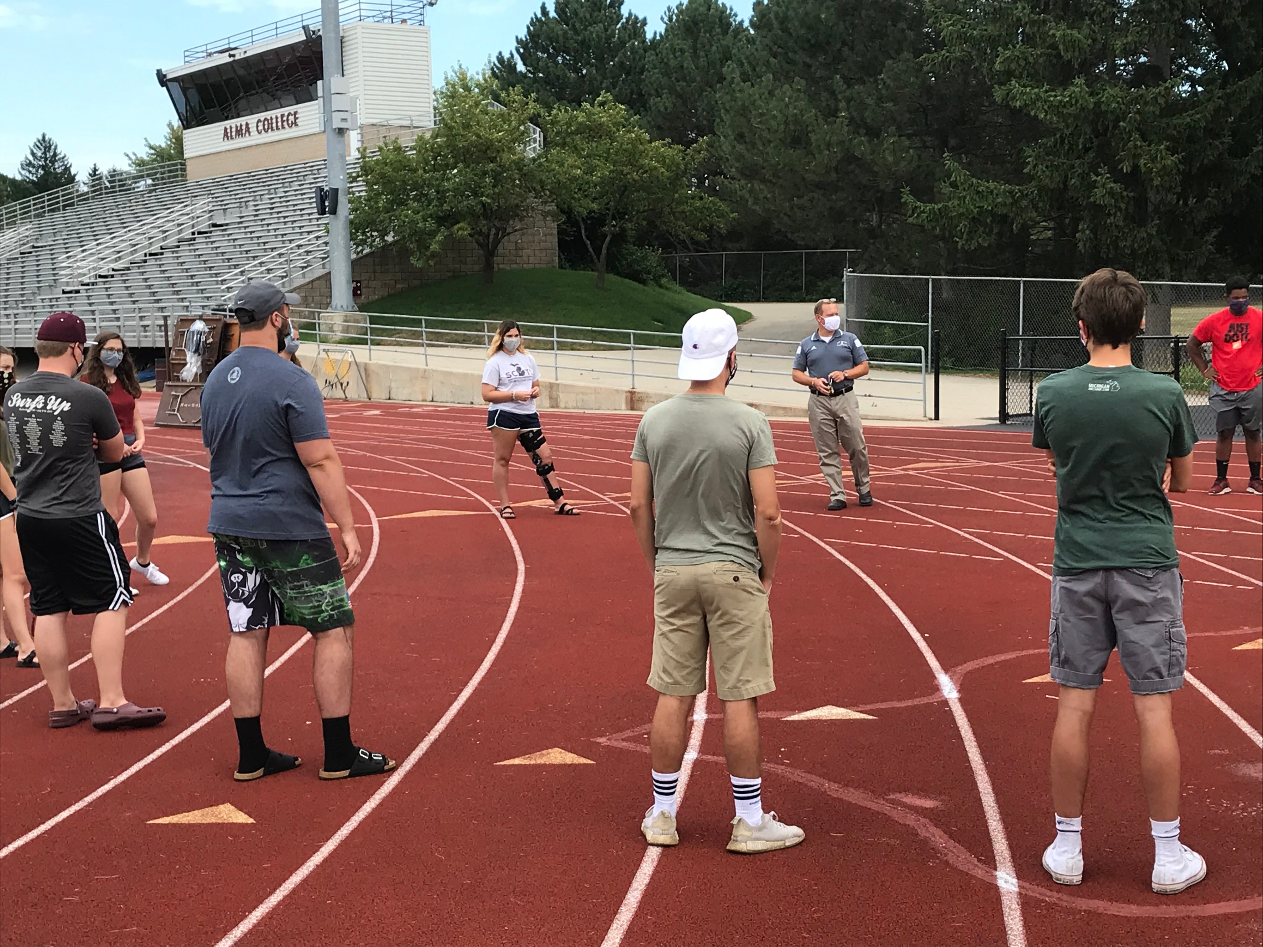 The First Year Seminar class, being taught by Phillip Andre escaped a hot classroom and moved outside to the track surrounding the school's football field.