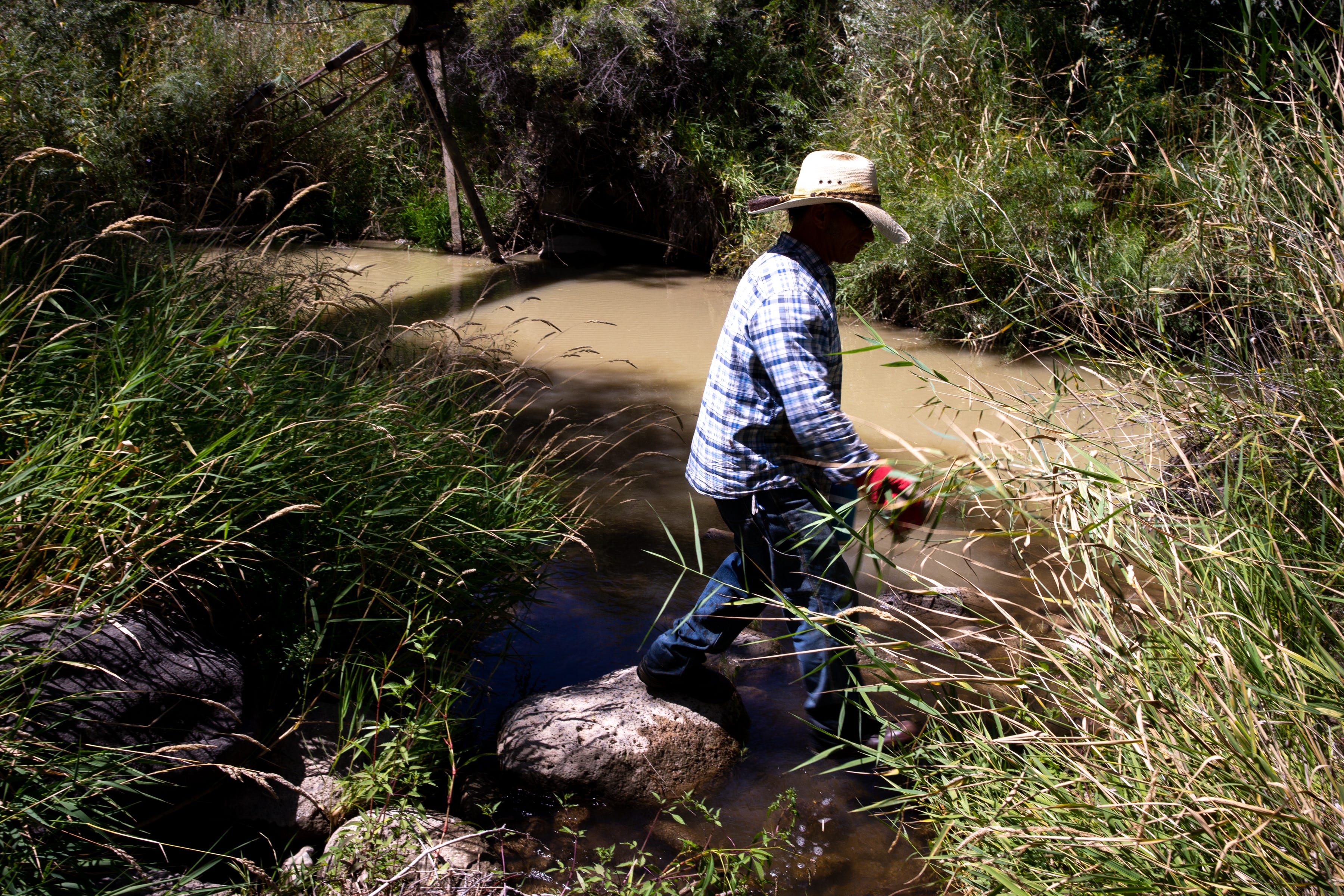 Top photos: Where Kiser Creek meets Big Ditch, it is a flowing stream in August 2021 (left). But downstream of the ditch (right), Kiser Creek's path can barely be seen; the ditch has diverted all its water. The Big Ditch moves water laterally, ending at Surface Creek. Downstream, it meets Tongue Creek, where David Cocetti, owner of Tongue Creek Ranch, stands at the confluence. Irrigation diversions along these creeks can use every drop of water that comes off the mesa top.