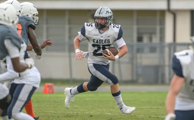 South Lake's Terry Falcone (25) looks for running room against Leesburg on Aug. 27 at H.O. Dabney Stadium in Leesburg. [PAUL RYAN / CORRESPONDENT]