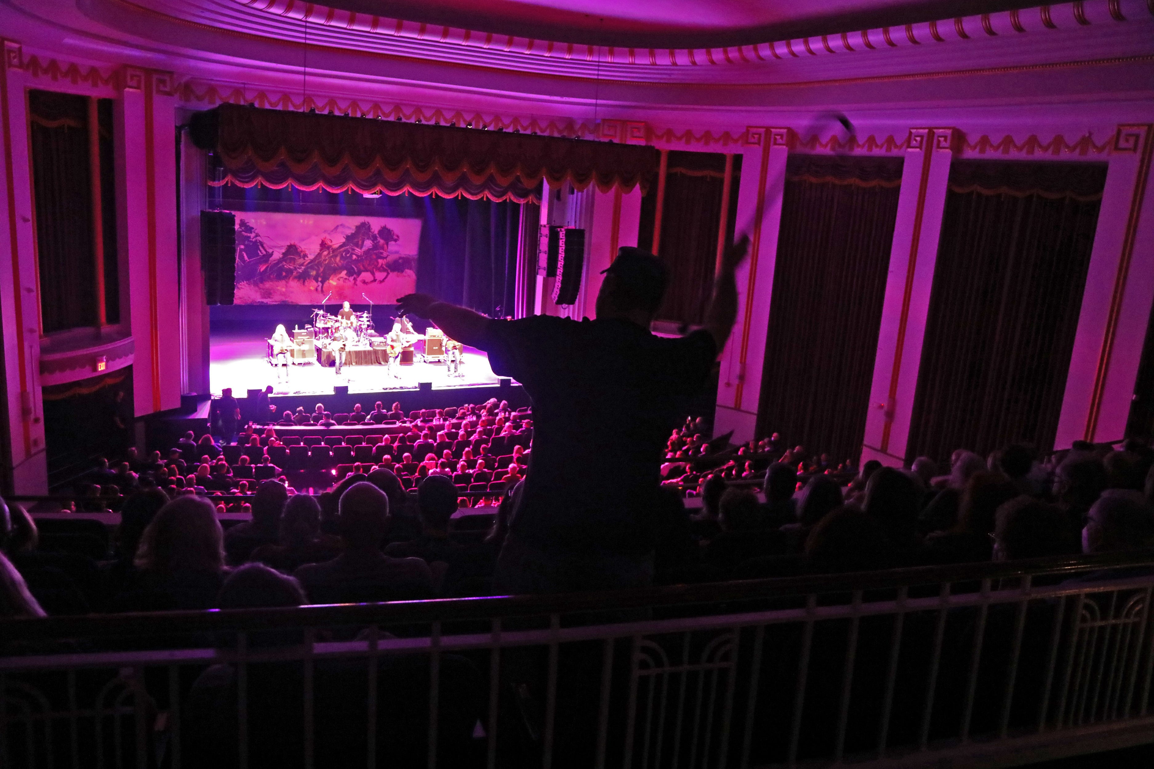 A concertgoer dances in the balcony during the Outlaws set at the Mayo Performing Arts Center on South Street prior to The Marshall Tucker Band taking the stage on October 15, 2021.