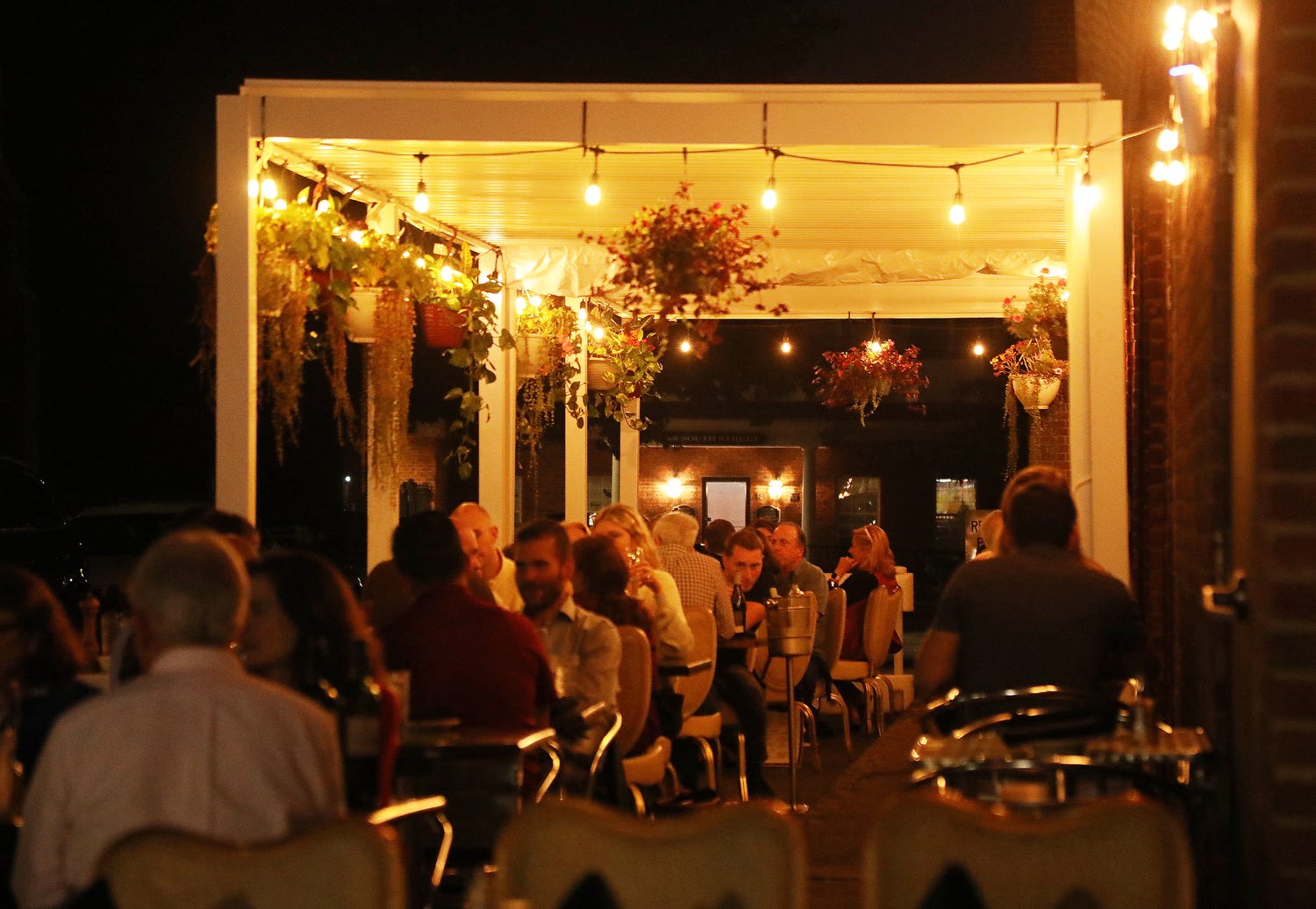 Diners take in an evening meal outside at Provisi, an Italian restaurant located on South Street, on October 7, 2021.