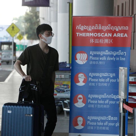A tourist wearing a face mask enters an area of th