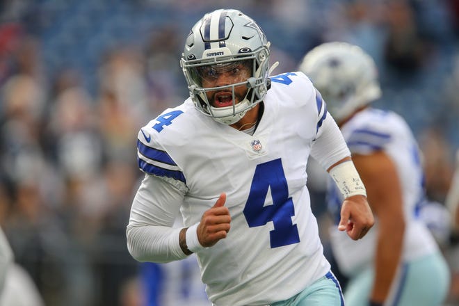 Dallas Cowboys quarterback Dak Prescott (4) warms up prior to an NFL football game against the New England Patriots, Sunday, Oct. 17, 2021, in Foxborough, Mass.