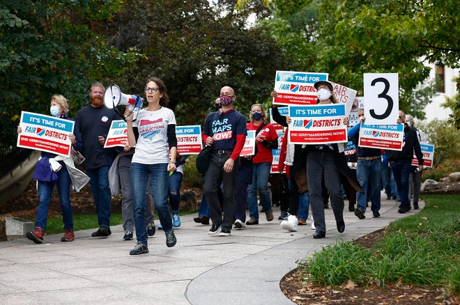 Supporters of Fair Districts in Ohio march around the Ohio Statehouse in Columbus, Ohio, after the Ohio Redistricting Commission held a meeting on Thursday, Oct. 28, 2021.