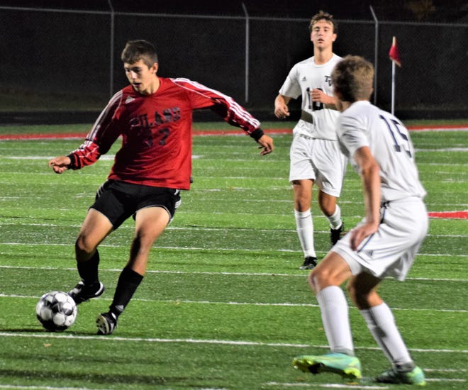 Hiland's Zeke Bodiker assists on a Reese Mullet goal in district play.