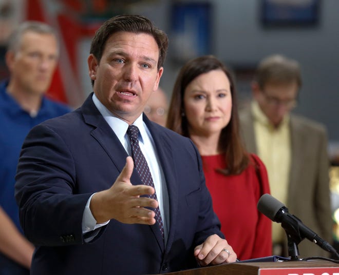 Florida Governor Ron DeSantis flanked by Attorney General Ashley Moody and supporters addresses the media and supporters on the states intent to file a lawsuit suing the Biden administration over Vaccine mandates on Federal workers that he says will devastate Florida jobs especially in the Aerospace industry. Florida Air Museum at the Sun n'Fun Campus in Lakeland Fl. October 28th 2021. Special to the Ledger/ Calvin Knight