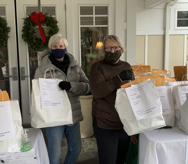 The Needham Community Council will provide Thanksgiving dinner to Needham residents who are at their homes for the holiday. Pictured are Judy Lambert and Sandra Robinson delivering meals in 2020.