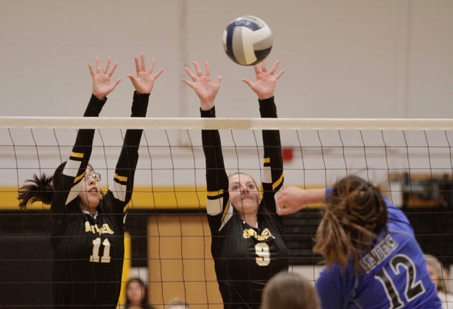 Bethany Avalos and Allie Gullett attempt to block a ball in Snyder's match against Lake View on Tuesday.