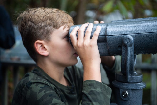 Jordan Whitehead, 12, looks into the 13th colorblind viewfinder at Radnor Lake State Park , a ceremony for seven guests came to visit the Nashville park, Thursday, Oct. 28, 2021, to test out the viewfinder.