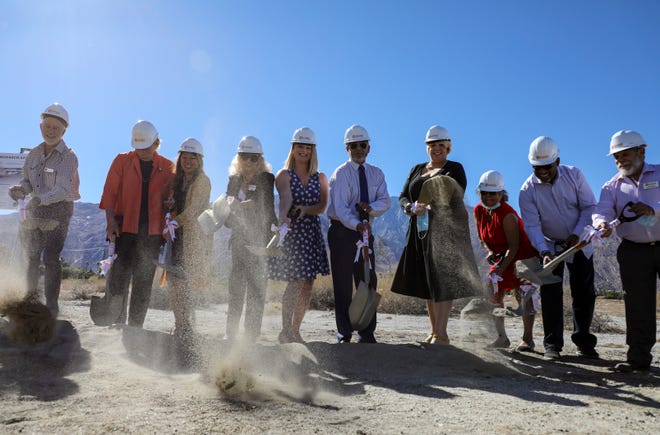 Palm Springs Mayor Christy Holstege (left of center) and Riverside County Supervisor V. Manuel Pérez (right of center) turn shovels alongside other state and local leaders during a groundbreaking ceremony for the Monarch Apartment Homes, Thursday, Oct. 28, 2021, in Palm Springs, Calif. 