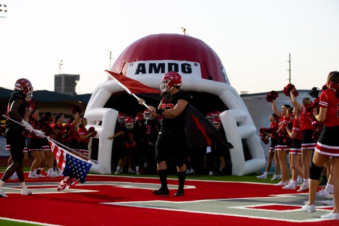 9/3/2021 Phoenix, AZ, Brophy v St. Mary, Connor Young carriers the flag as the Broncos run onto the field. By Zac BonDurant/Special to the Republic