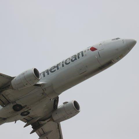 An American Airlines plane takes off at Miami Inte