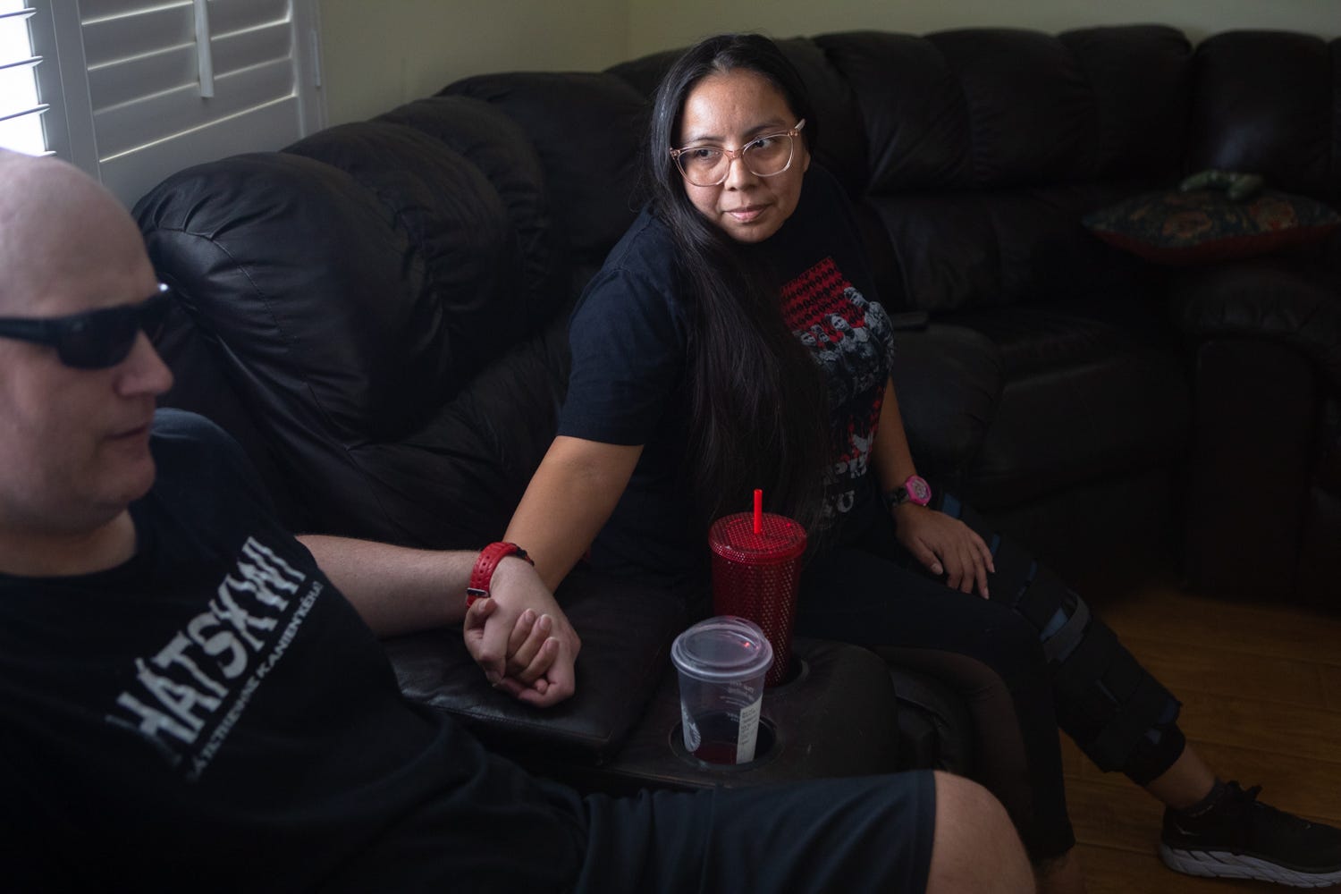 Rainelle Wolfe holds her husband Kiowa's hand while talking to reporters at their home in Santee, Aug. 5, 2021.