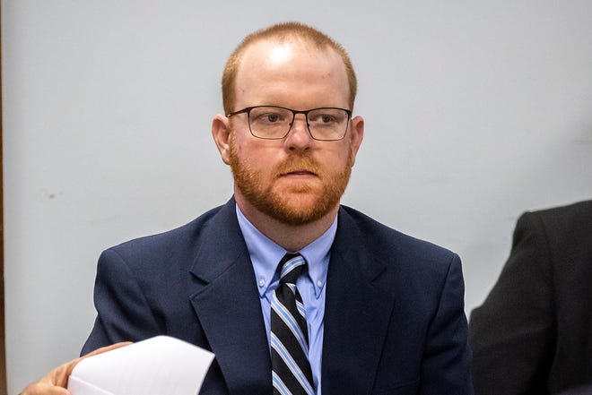 Travis McMichael listens to attorneys questioning a group of potential jurors during the jury selection process for the trial of him and his father Greg McMichael and William "Roddie" Bryan, at Glynn County Courthouse on October 25, 2021, in Brunswick.