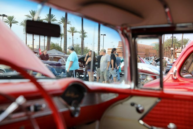 Pedestrians check out the many cars on display at the Rock ‘n’ Roll Classic Car Show on Oct. 23, 2021.