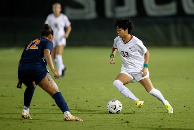 Florida State University's Yujie Zhao (33) dribbles the ball during a game between FSU and the University of Virginia at the Seminole Soccer Complex Thursday, Oct. 28, 2021.
