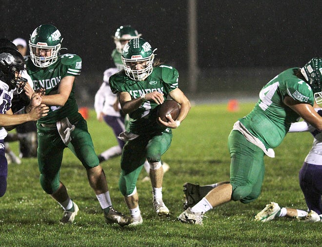 Mendon tailback Evan Lukeman rushes through a massive hole made by the offensive line against Lawrence on Friday night.