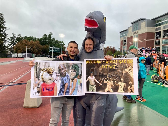 Michigan fan Travis Bowen and Michigan State fan Matt Casterline head into ESPN College GameDay at Spartan Stadium.