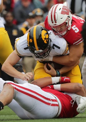 Wisconsin linebacker Leo Chenal sacks Iowa quarterback Spencer Petras in October. Chenal led UW in tackles for loss (17½) and total tackles (114) and finished second in sacks (eight) despite missing the first two games.