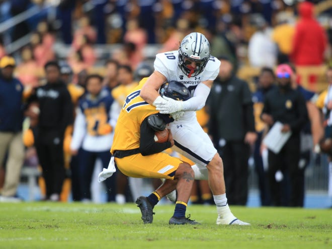 Monmouth's Eddie Hahn (10) tackles North Carolina A&T punter Mike Rivers (47) after a muffed snap during the first quarter of Monmouth's 35-16 win in Greensboro, North Carolina on Oct. 30, 2021.