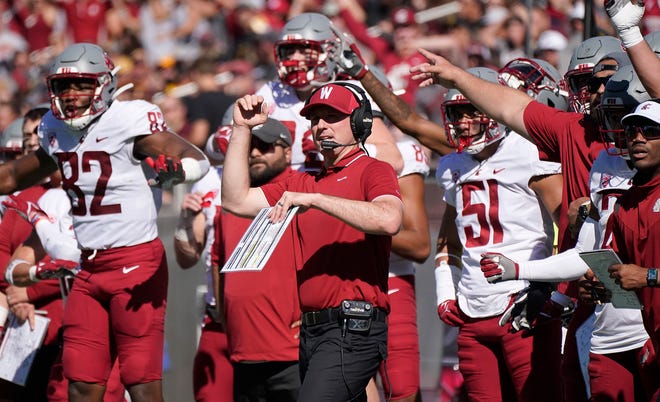 Washington State acting head coach Jake Dickert and his team celebrate a missed field goal by Arizona State during the first half of an NCAA college football game, Saturday, Oct 30, 2021, in Tempe, Ariz. (AP Photo/Darryl Webb)
