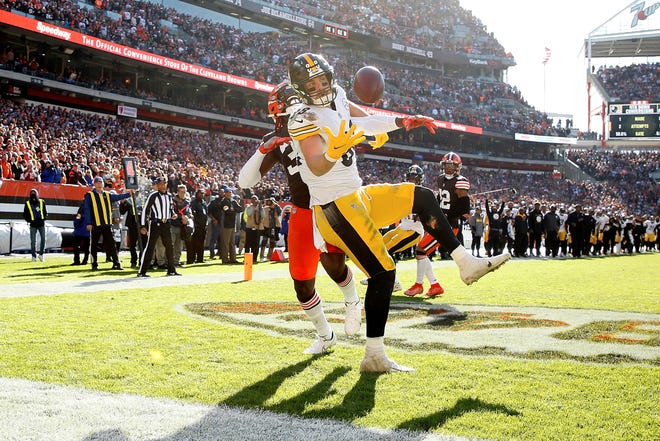 Pittsburgh Steelers tight end Pat Freiermuth (88) catches a pass for a touchdown while being defended by Cleveland Browns safety Ronnie Harrison Jr. (33) during an NFL football game, Sunday, Oct. 31, 2021, in Cleveland. (AP Photo/Kirk Irwin)