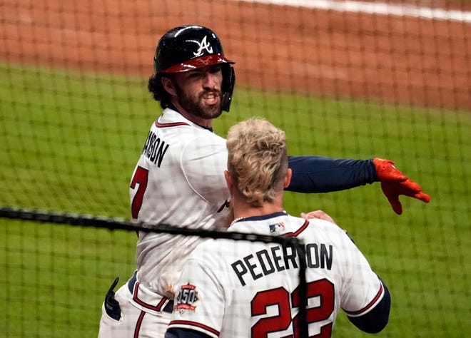 Dansby Swanson celebrates his homer in the seventh inning of Game 4.