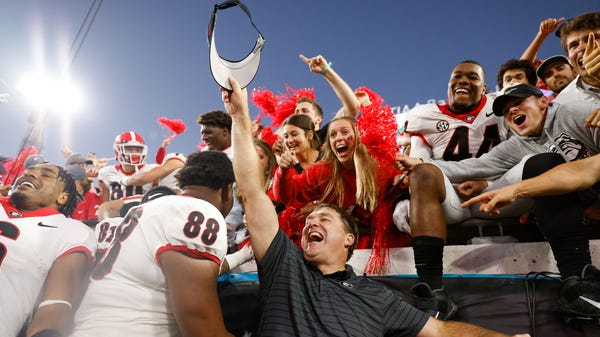 Georgia head coach Kirby Smart celebrates with fan
