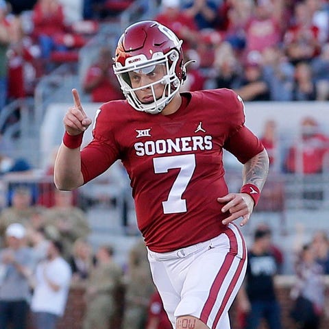 Oklahoma's Spencer Rattler reacts after throwing a