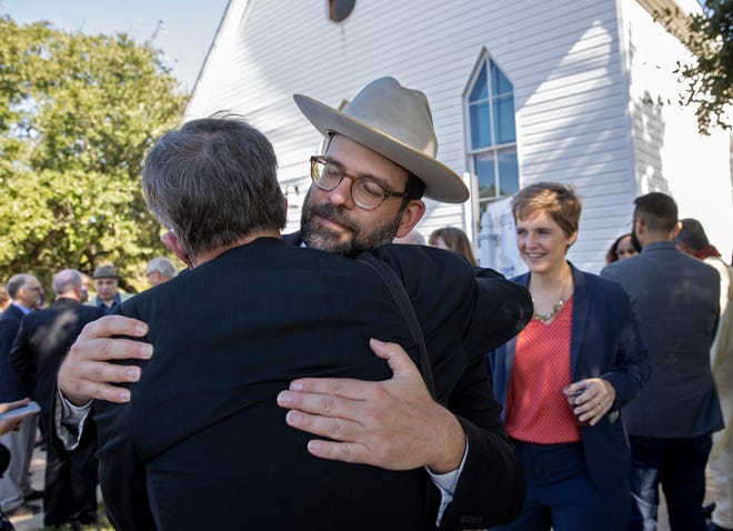 Rabbi Neil Blumofe, right, of Congregation Agudas Achim, hugs Rev. Jim Rigby of St. Andrew's Presbyterian Church on Nov. 1 as leaders of the faith community gathered to support the Jewish community after recent antisemitic acts.