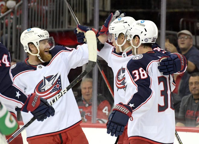 Columbus Blue Jackets right wing Patrik Laine celebrates his goal with Jakub Voracek, left, and Boone Jenner (38) during the first period of an NHL hockey game against the New Jersey Devils, Sunday, Oct. 31, 2021, in Newark, N.J.