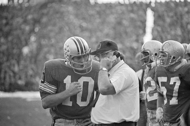 Ohio State quarterback Rex Kern and coach Woody Hayes talk during a game against Michigan on November 2.  23, 1968.