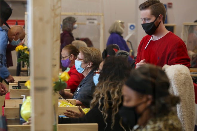 Poll workers check voters in during early voting at the Franklin County Board of Elections in Columbus, Ohio Nov. 1.