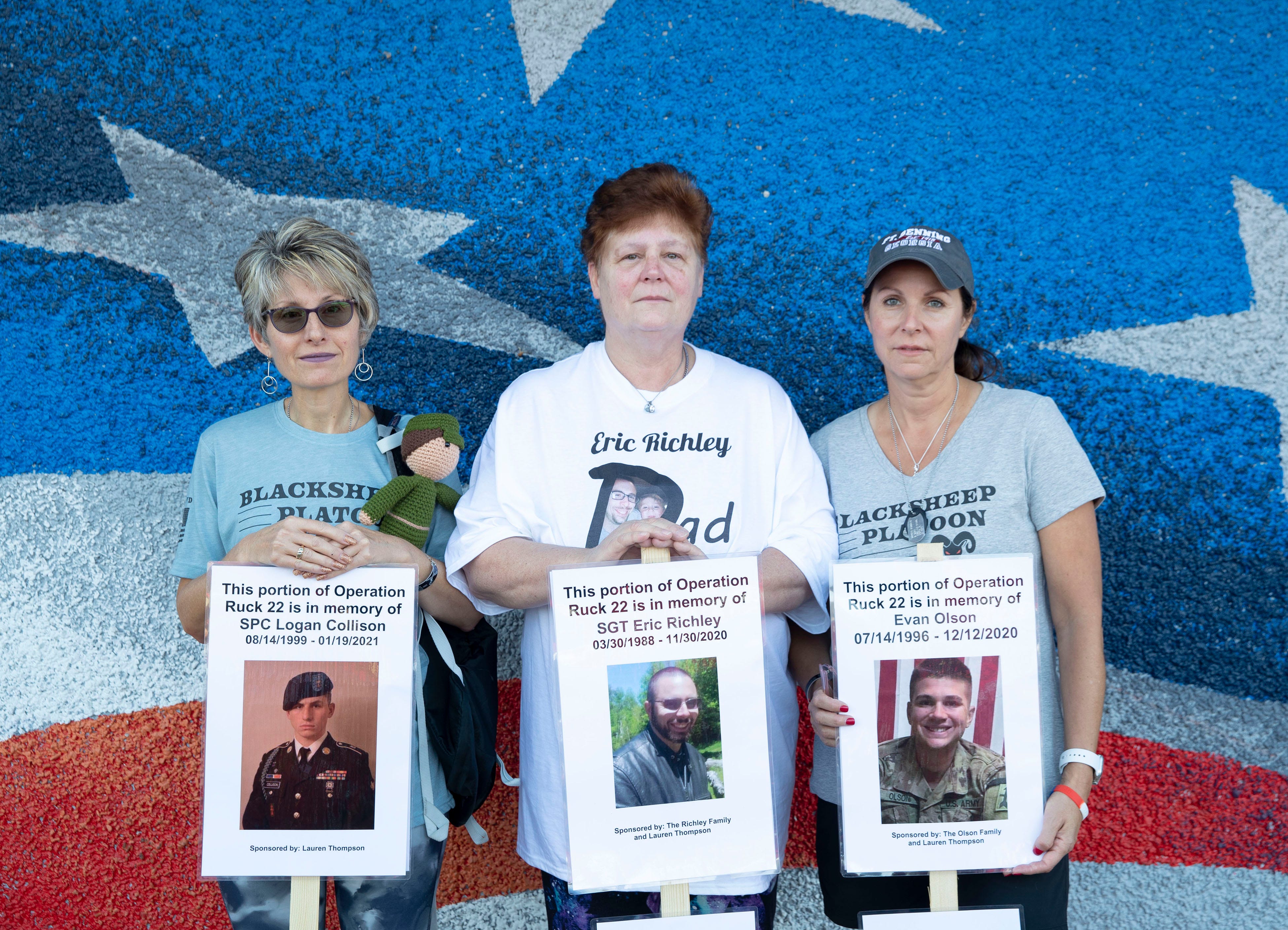 Linda Collison, Kathy Richley and Juli Olson hold posters of their sons, Logan Collison, Eric Richley and Evan Olson, at a memorial march  in October in Madison.