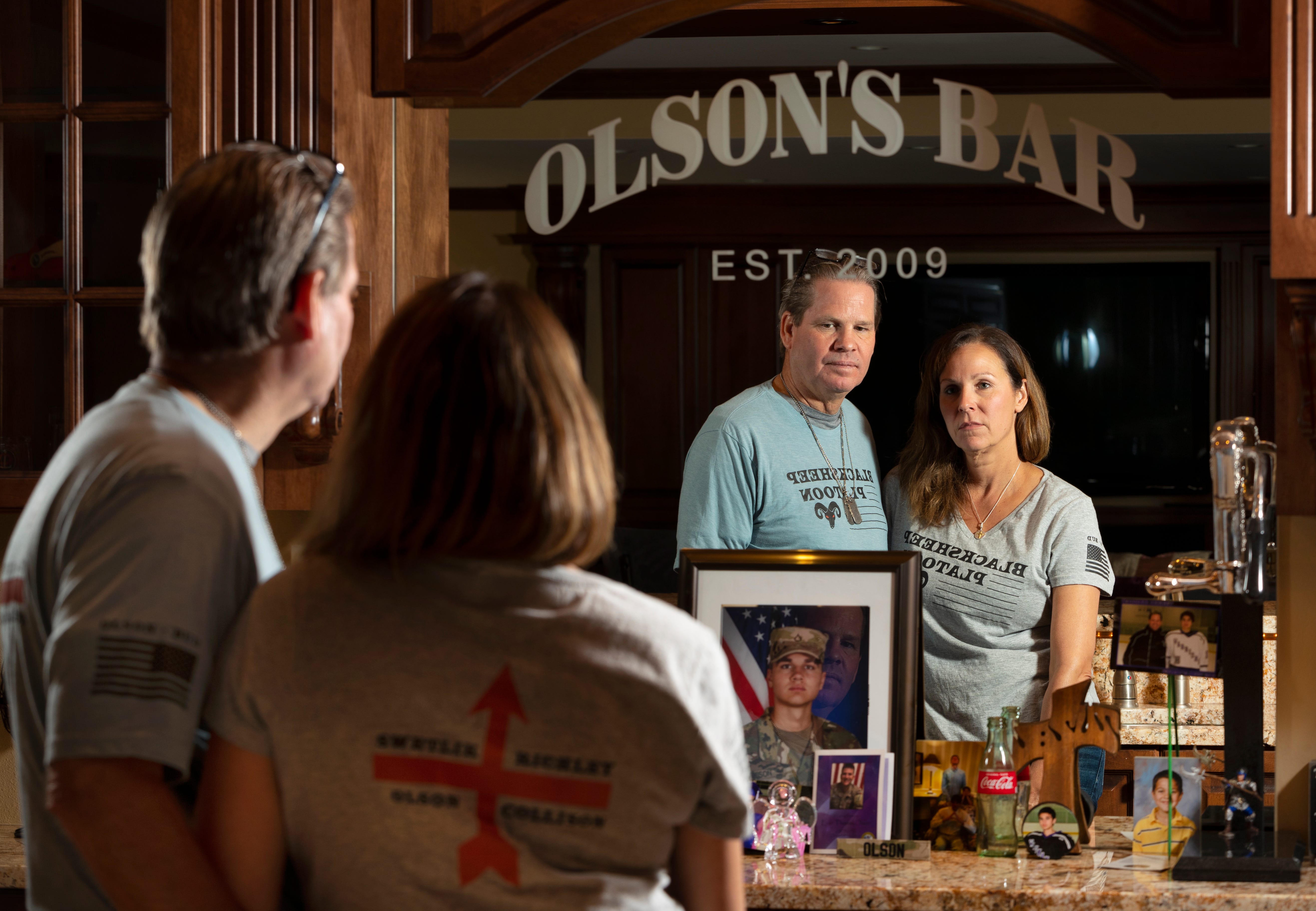 Eric and Juli Olson are shown with a memorial to their son, Evan, at their home in Waunakee, Wisconsin. Their son, Evan, who was a member of the Wisconsin National Guard, committed suicide in December 2020.