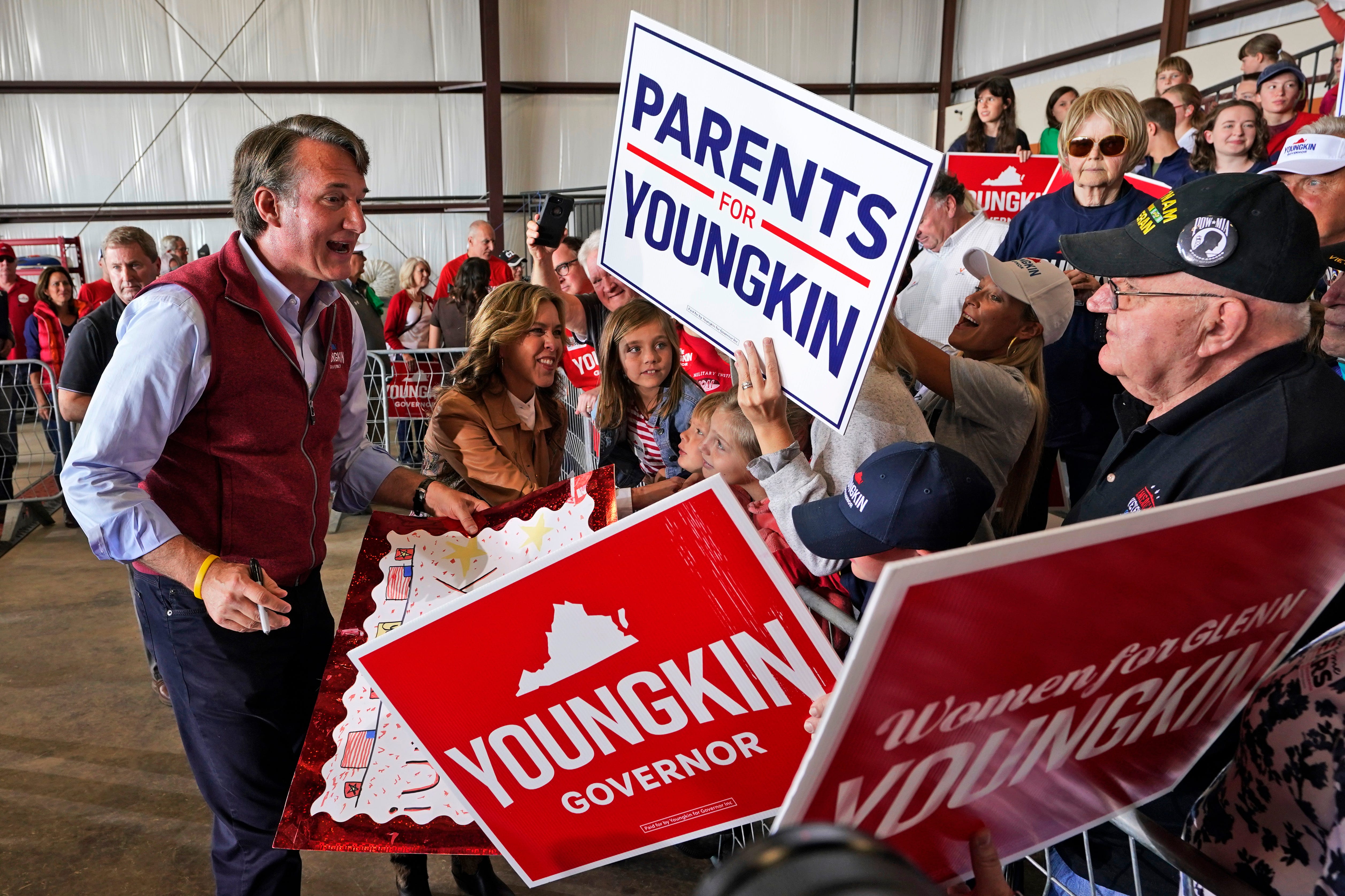 Republican gubernatorial candidate Glenn Youngkin and his wife, Suzanne, second from left, greet supporters during a rally in Chesterfield, Va., on Nov. 1, 2021.