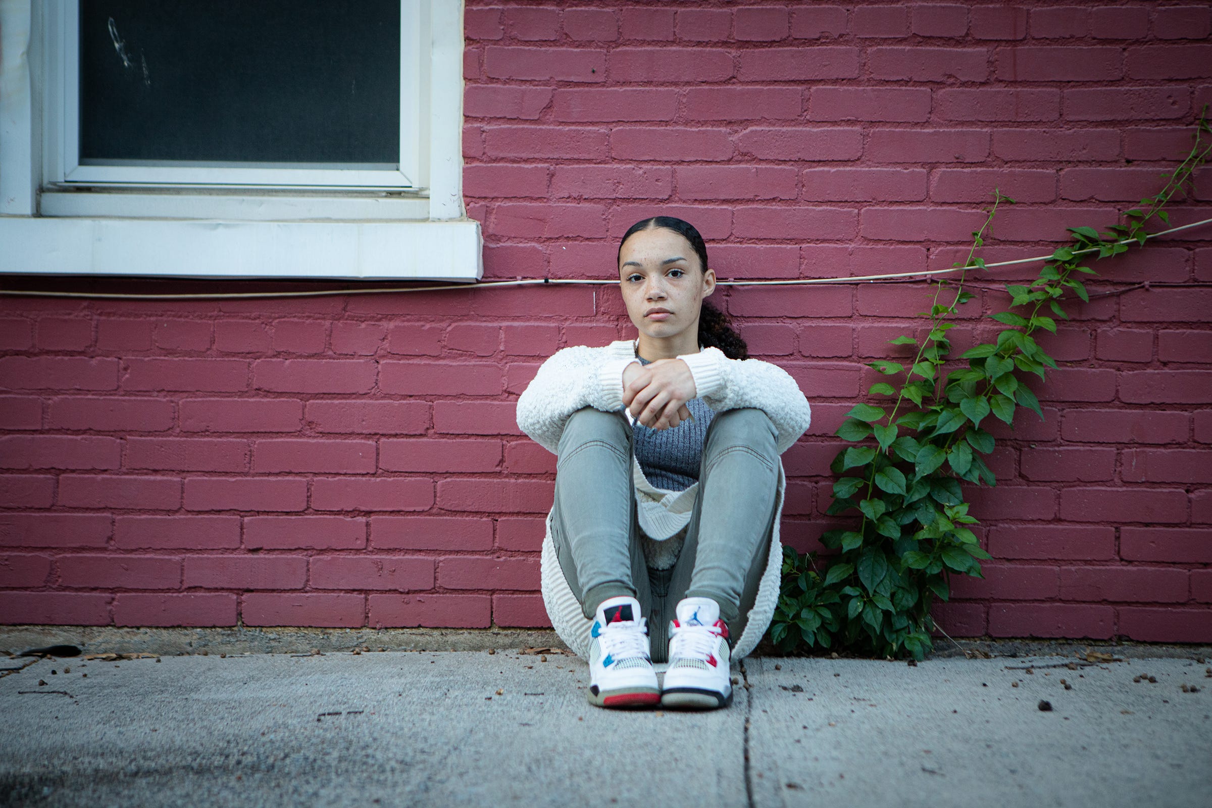 Brianna Stuart sits near the building where she encountered police in September 2016. Friday, October 8, 2021.