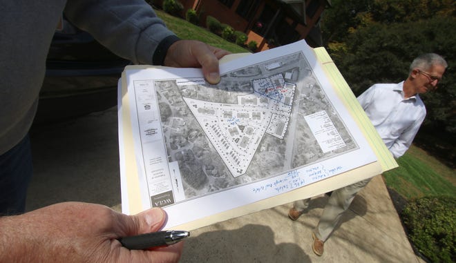 Planters Ridge Resident Bob Ferguson holds the site plan of the proposed 194-unit apartment proposed by the Gastonia-based real estate company Southwood Realty.