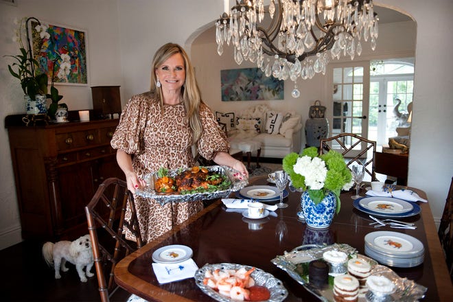 Robin Ganzert, president and CEO of American Humane, serves spatchcock chicken at her West Palm Beach home. The group's 11th annual Hero Dog Awards gala will be held Friday at Eau Palm Beach Resort.