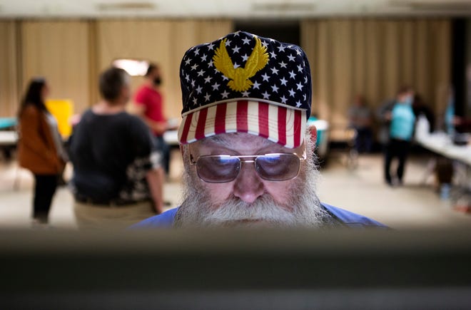 Dennis Smith, of Newark, casts his ballot on one of the electronic voting machines at the American Legion Post 85 on Election Day in Newark, Ohio on November 2, 2021.